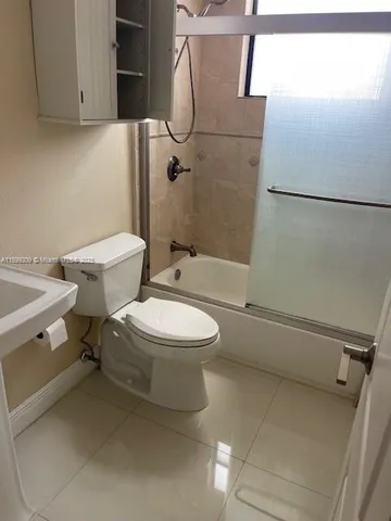 a white toilet sitting next to a bathroom sink