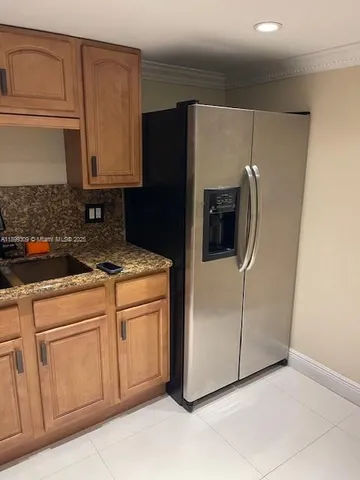 a kitchen with stainless steel appliances white cabinets and a refrigerator