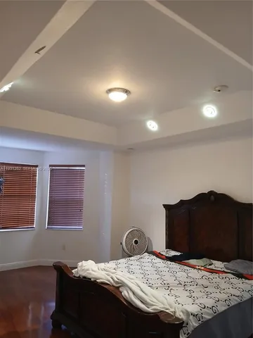 a bed sitting in a bedroom next to a lamp