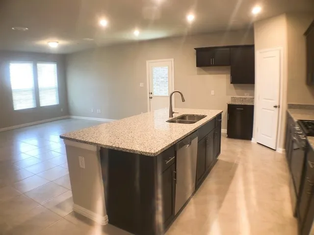 a kitchen with a sink and a refrigerator