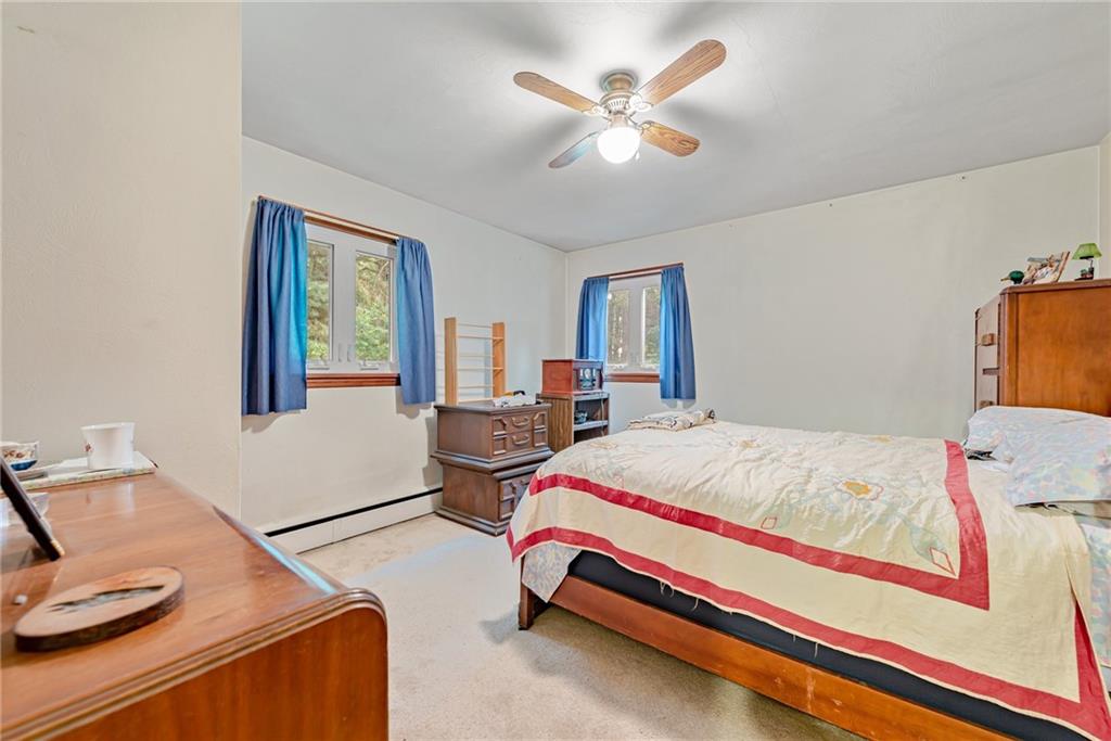 27 Matson Road Ligonier, PA 15658 - Photo 11 of 24 a bedroom with a bed and a chandelier