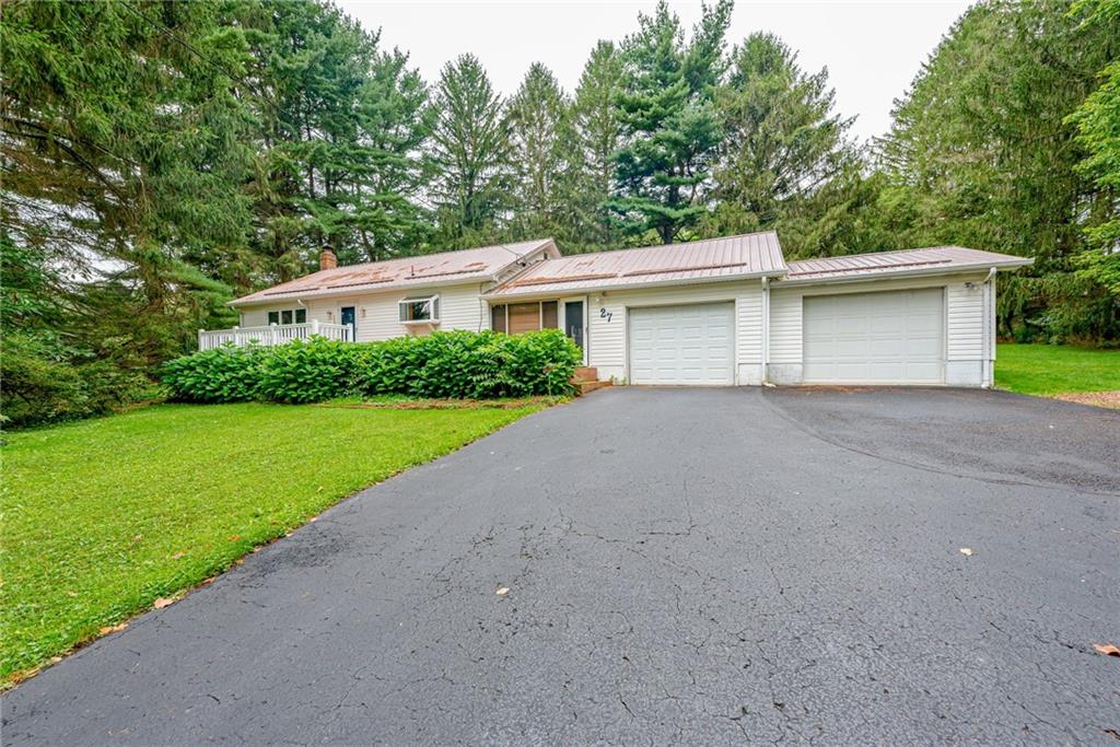 27 Matson Road Ligonier, PA 15658 - Photo 20 of 24 front view of house with a yard and trees all around