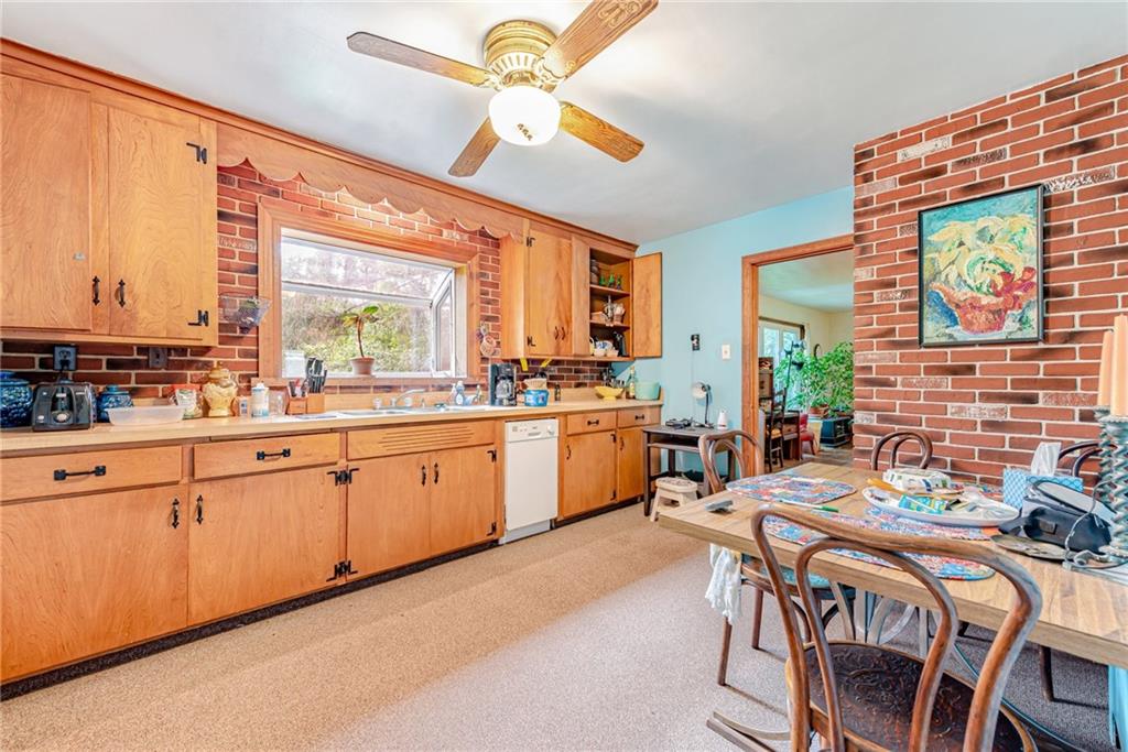 27 Matson Road Ligonier, PA 15658 - Photo 7 of 24 a kitchen with stainless steel appliances kitchen island granite countertop a stove a sink a dining table and chairs with wooden floor