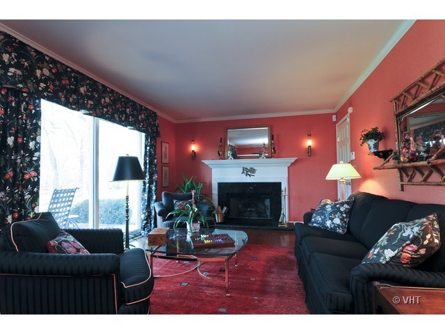 34 North Ridge Road Lake Forest, IL 60045 - Photo 2 of 8 a living room with furniture a fireplace and a floor to ceiling window