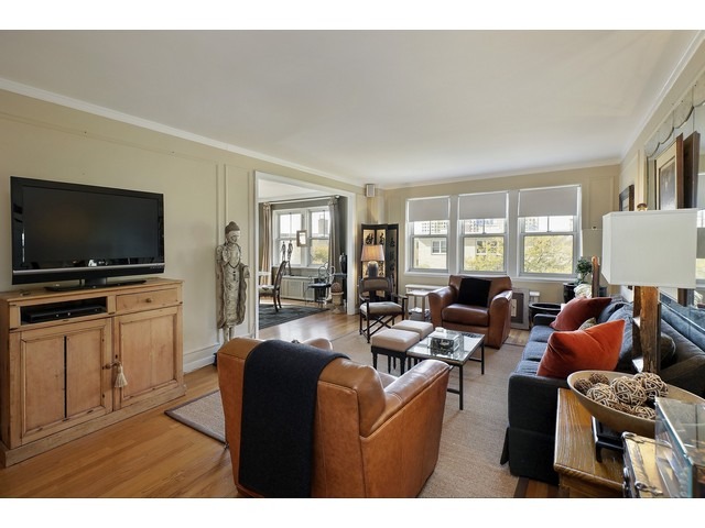 5555 North Sheridan Road, Unit 307 Chicago, IL 60640 - Photo 4 of 10 a living room with furniture and a flat screen tv
