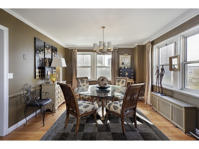5555 North Sheridan Road, Unit 307 Chicago, IL 60640 - Photo 5 of 10 a view of a dining room with furniture window and wooden floor