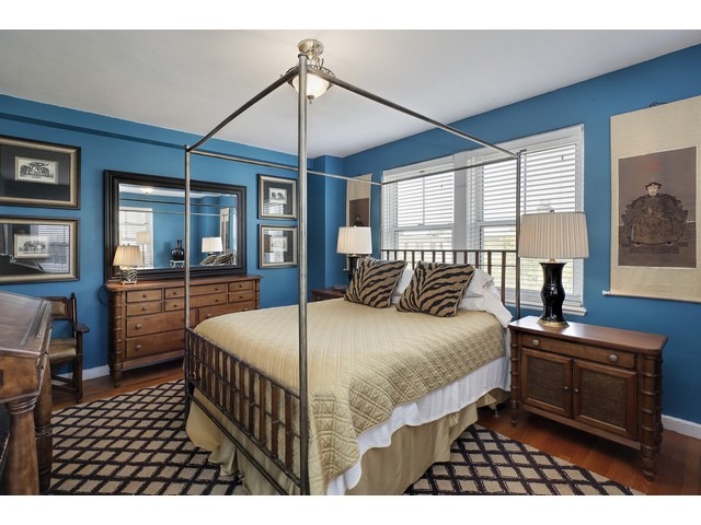 5555 North Sheridan Road, Unit 307 Chicago, IL 60640 - Photo 7 of 10 a bed room with a bed and a chandelier
