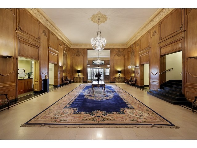 5555 North Sheridan Road, Unit 307 Chicago, IL 60640 - Photo 8 of 10 a living room with table chairs and a chandelier