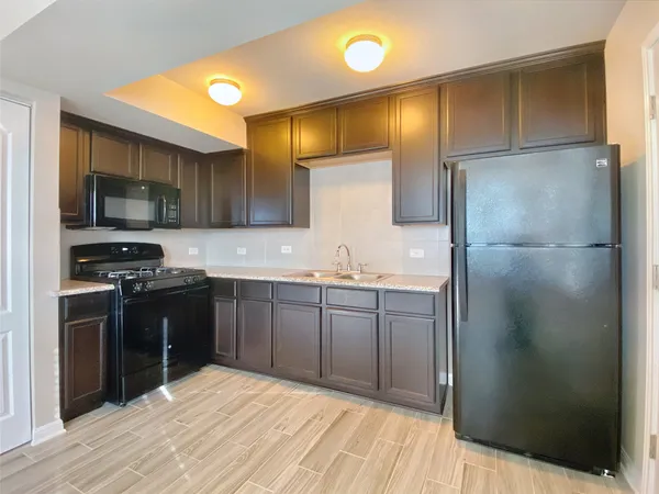 a kitchen with a sink stainless steel appliances and cabinets