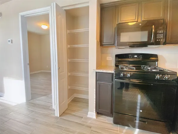 a kitchen with a refrigerator and a microwave