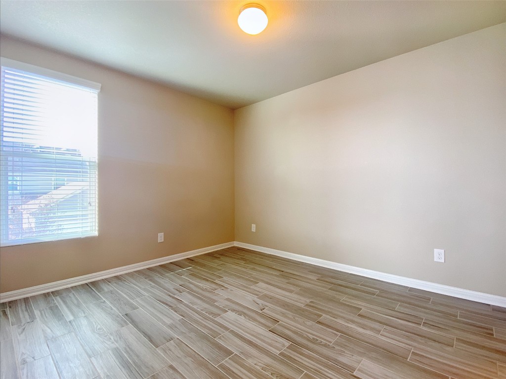 1721 Arbor Knot Drive, Unit GARAGE APARTMENT Kyle, TX 78640 - Photo 5 of 11 a view of an empty room with wooden floor and a window