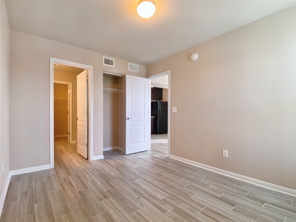 1721 Arbor Knot Drive, Unit GARAGE APARTMENT Kyle, TX 78640 - Photo 6 of 11 a view of an empty room with wooden floor and closet