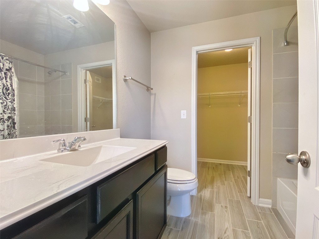 1721 Arbor Knot Drive, Unit GARAGE APARTMENT Kyle, TX 78640 - Photo 8 of 11 a bathroom with a sink a toilet and shower