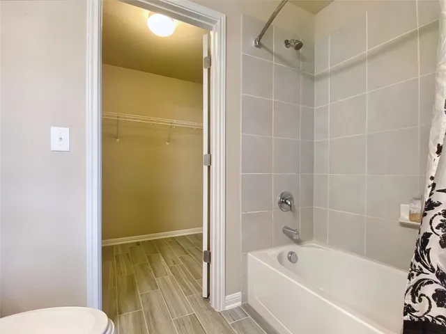 a bathroom with a bathtub and shower