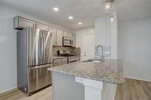 1304 Robin Street Houston, TX 77019 - Photo 2 of 11 Kitchen updated with contemporary finishes, granite countertops, SS appliances and separate pantry.