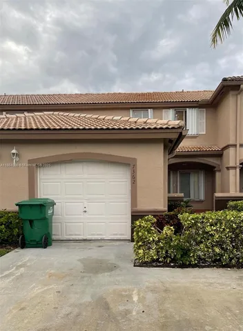front view of a house with a garden