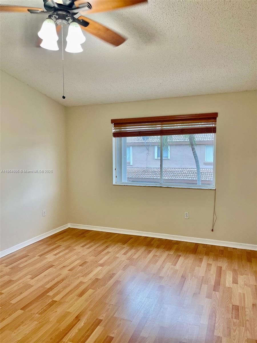 7362 Southwest 162nd Place Miami, FL 33193 - Photo 17 of 22 a view of a room with wooden floor and a ceiling fan