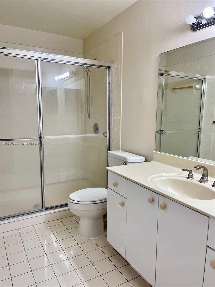 7362 Southwest 162nd Place Miami, FL 33193 - Photo 18 of 22 a bathroom with a sink toilet and shower