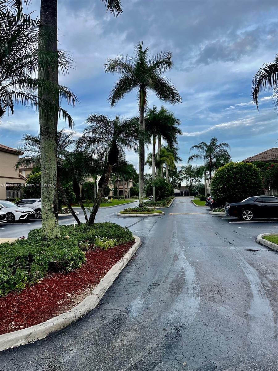 7362 Southwest 162nd Place Miami, FL 33193 - Photo 20 of 22 a view of a street with a cars parked on the roadside