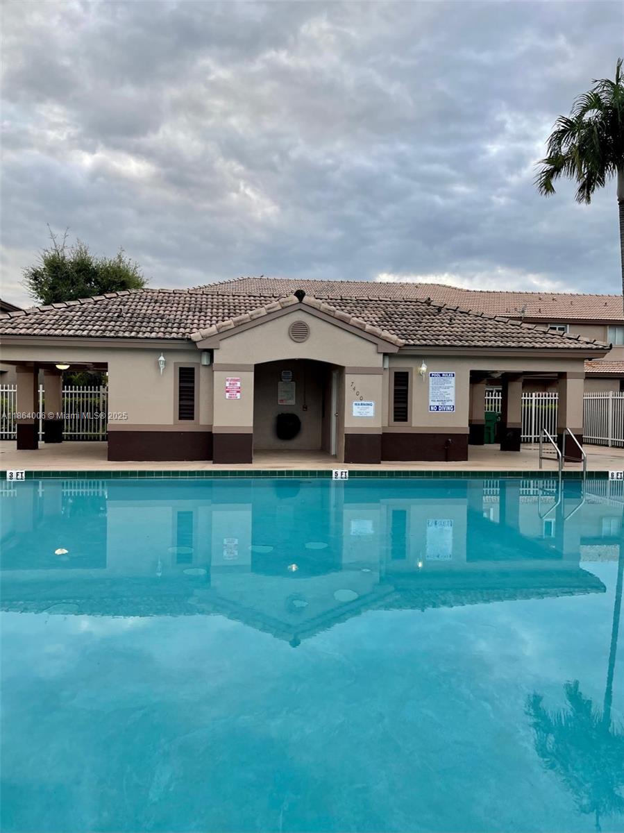 7362 Southwest 162nd Place Miami, FL 33193 - Photo 21 of 22 a front view of a house with a garden