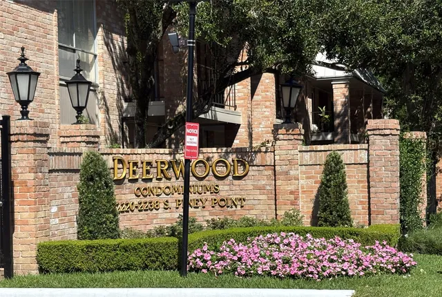 a view of a pathway house with wooden fence