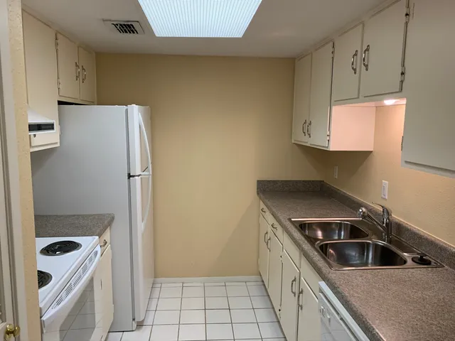 a kitchen with a refrigerator sink and stove