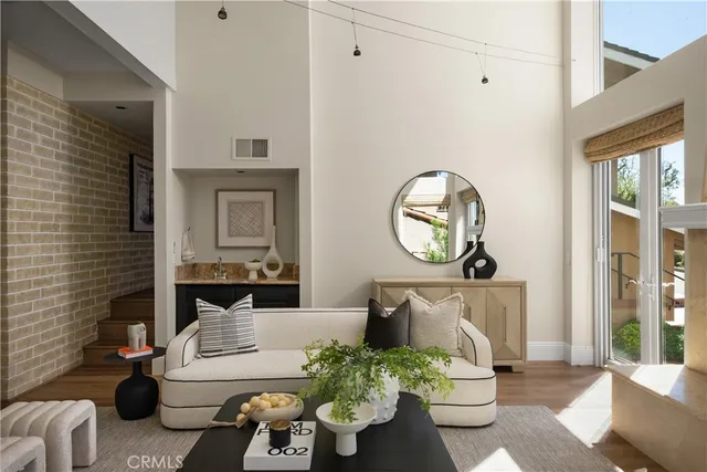 a living room with furniture and a potted plant
