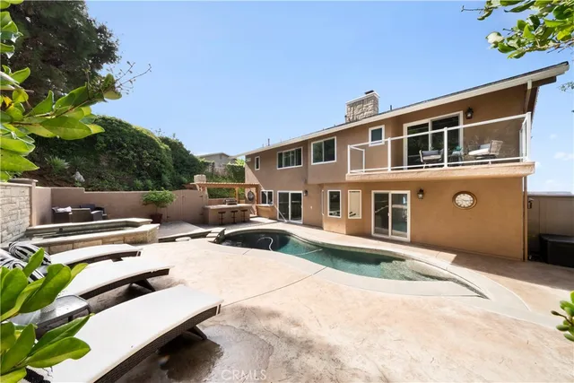 a view of swimming pool with outdoor seating and plants