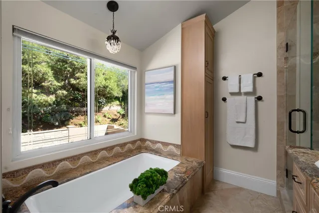 a bathroom with a granite countertop sink mirror vanity and toilet