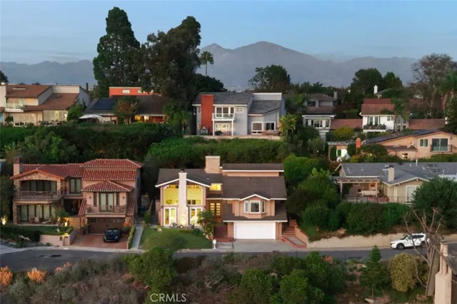 an aerial view of multiple houses with a yard