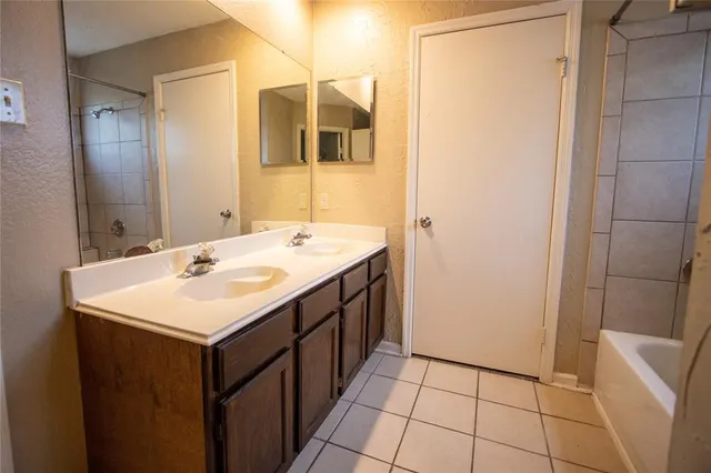a bathroom with a sink a mirror and a shower