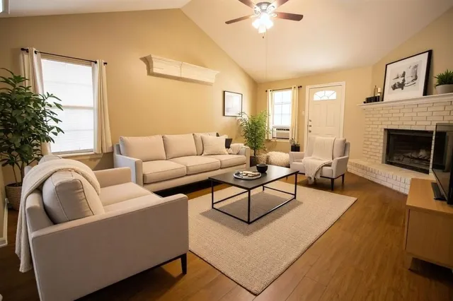 a living room with furniture and a fireplace