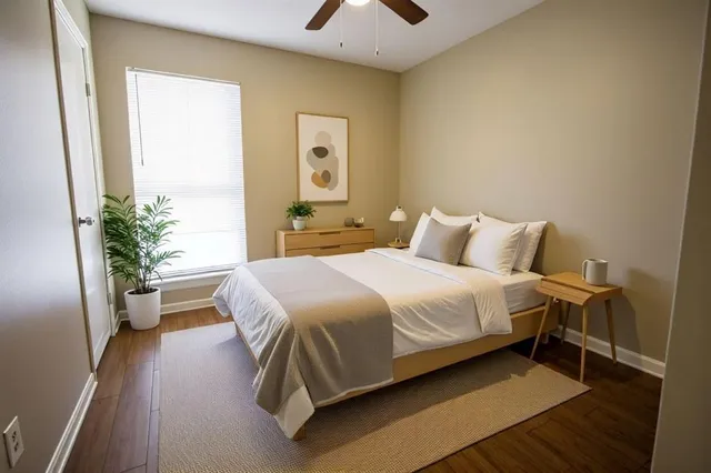 a bedroom with a bed and a potted plant