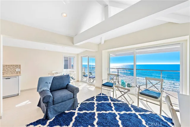 a living room with furniture a rug and a table