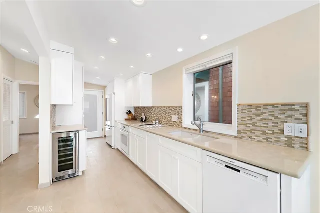 a view of a kitchen with a sink and dishwasher