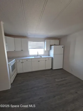 a view of a kitchen with wooden floor