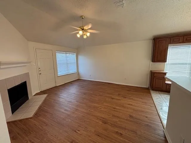 wooden floor in an empty room with a fireplace
