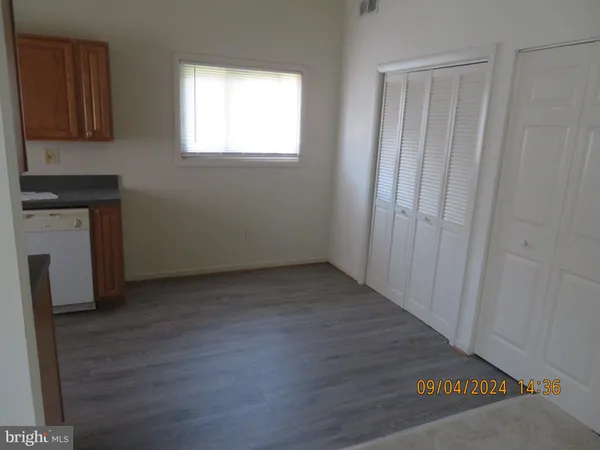 a view of a kitchen with wooden floor and a sink