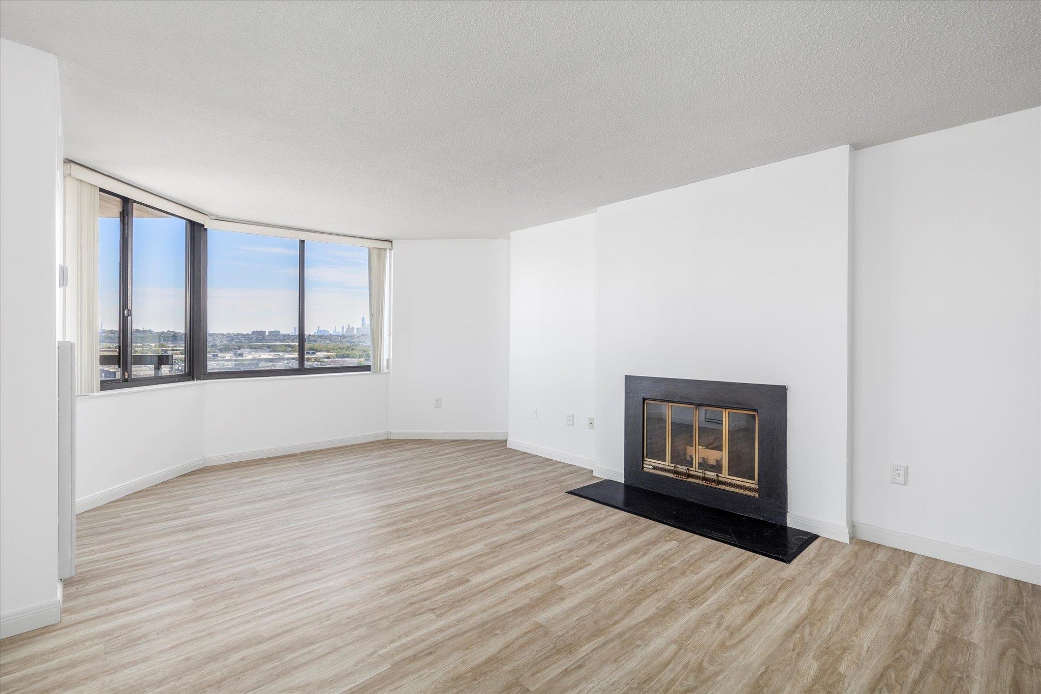 1705 Harmon Cove Tower, Unit 1705 Secaucus, NJ 07094 - Photo 15 of 49 a view of an empty room with wooden floor and a window