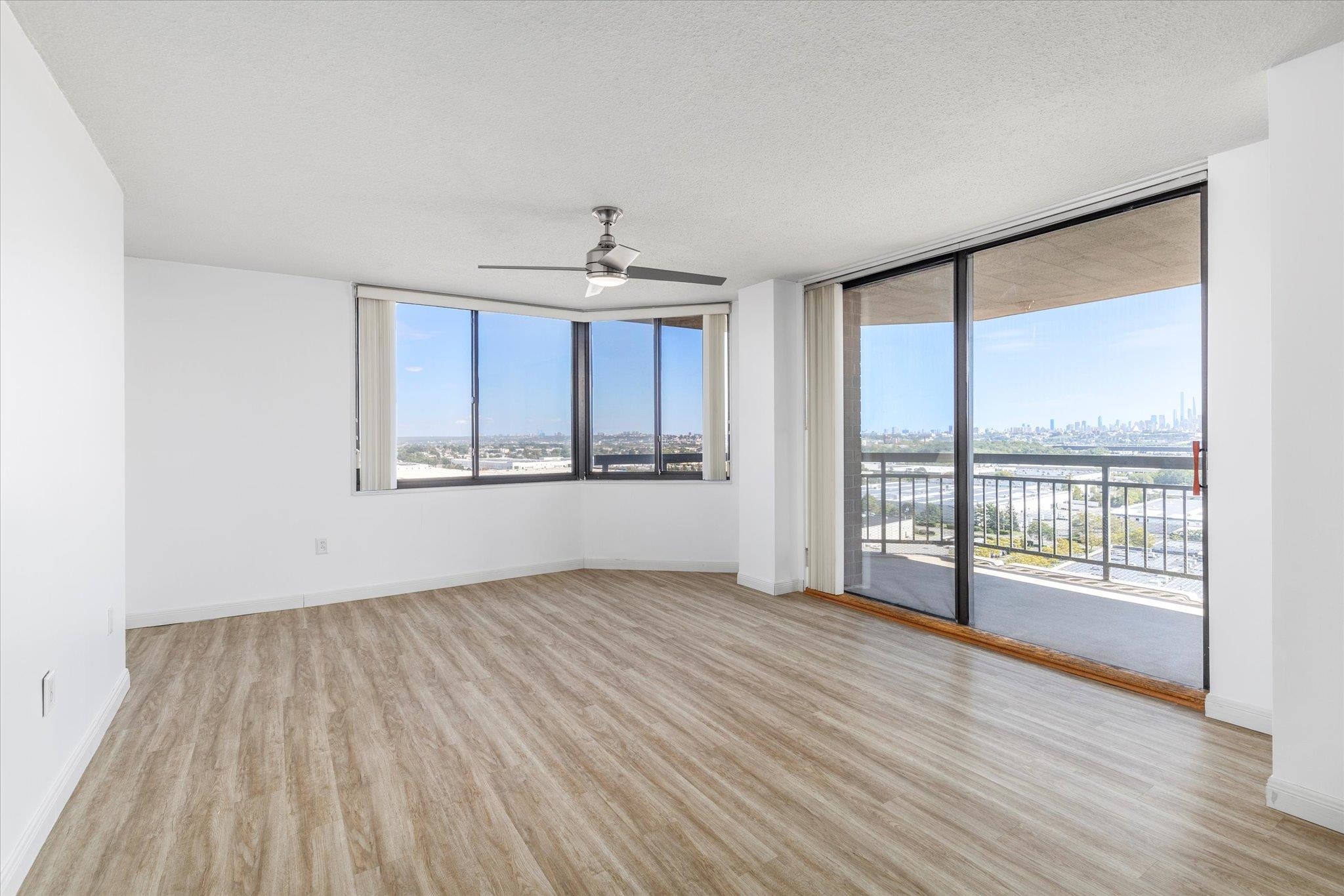 1705 Harmon Cove Tower, Unit 1705 Secaucus, NJ 07094 - Photo 16 of 49 an empty room with wooden floor and windows
