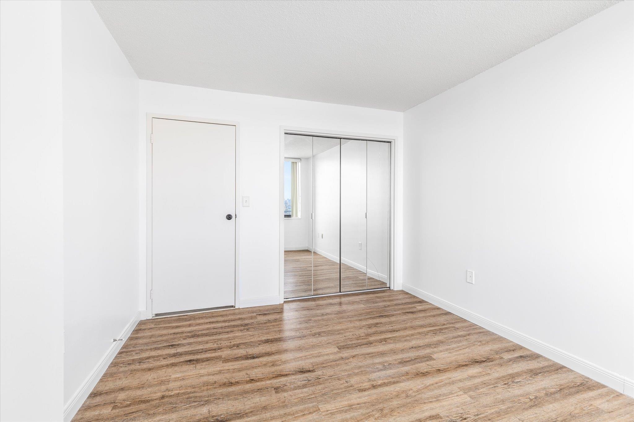 1705 Harmon Cove Tower, Unit 1705 Secaucus, NJ 07094 - Photo 31 of 49 a view of an empty room with wooden floor