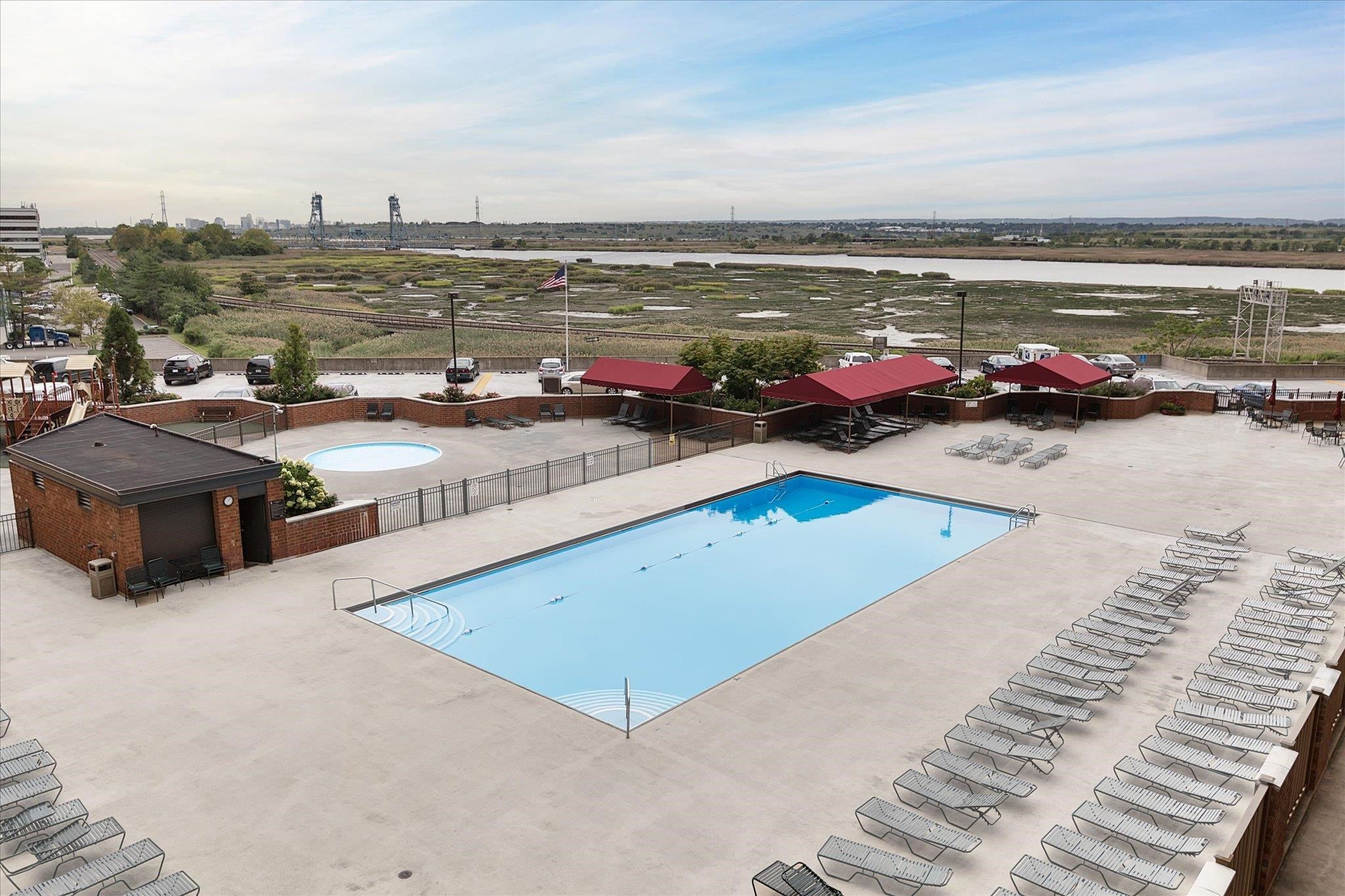 1705 Harmon Cove Tower, Unit 1705 Secaucus, NJ 07094 - Photo 34 of 49 a view of a swimming pool with an ocean view