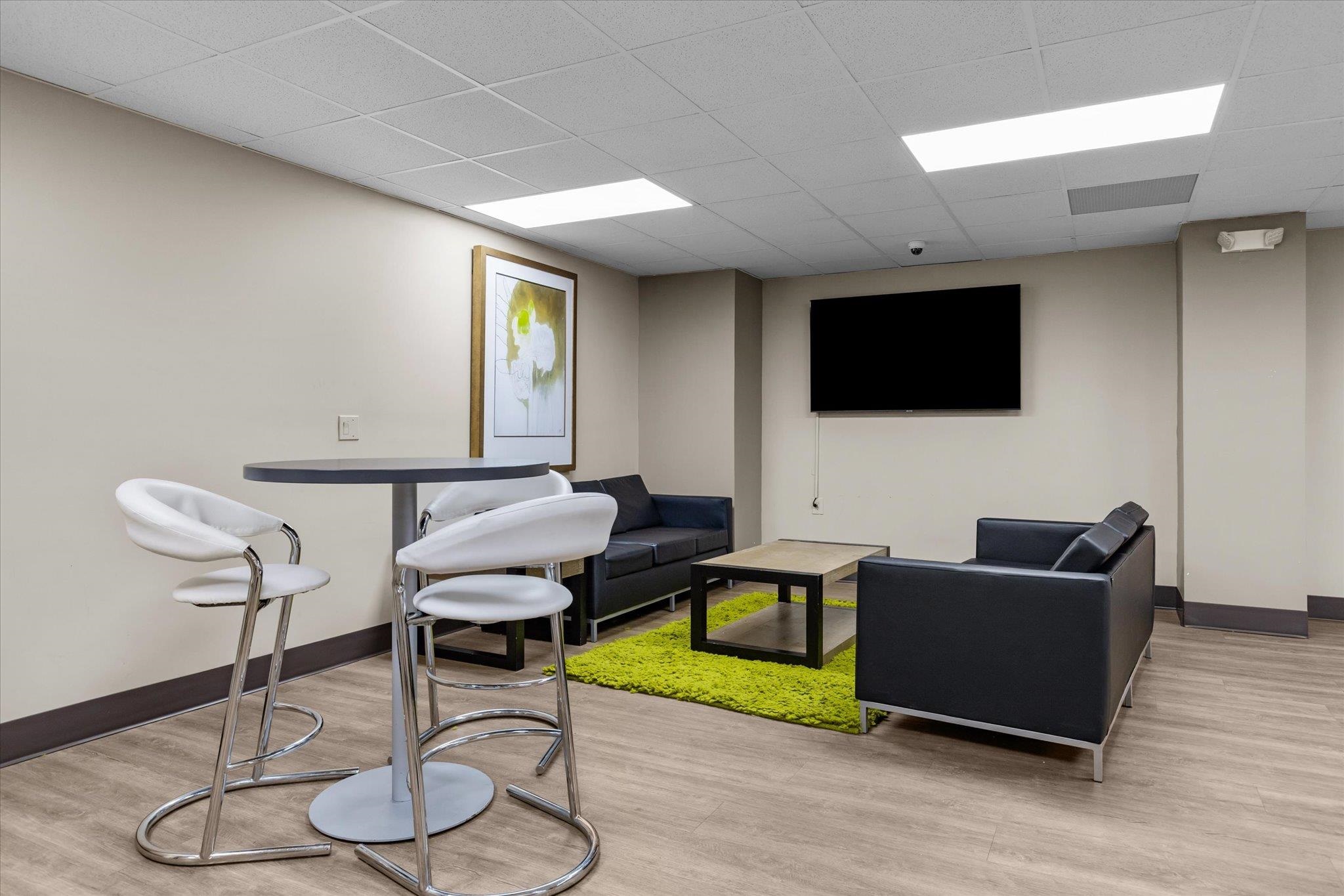 1705 Harmon Cove Tower, Unit 1705 Secaucus, NJ 07094 - Photo 39 of 49 a living room with furniture and a flat screen tv