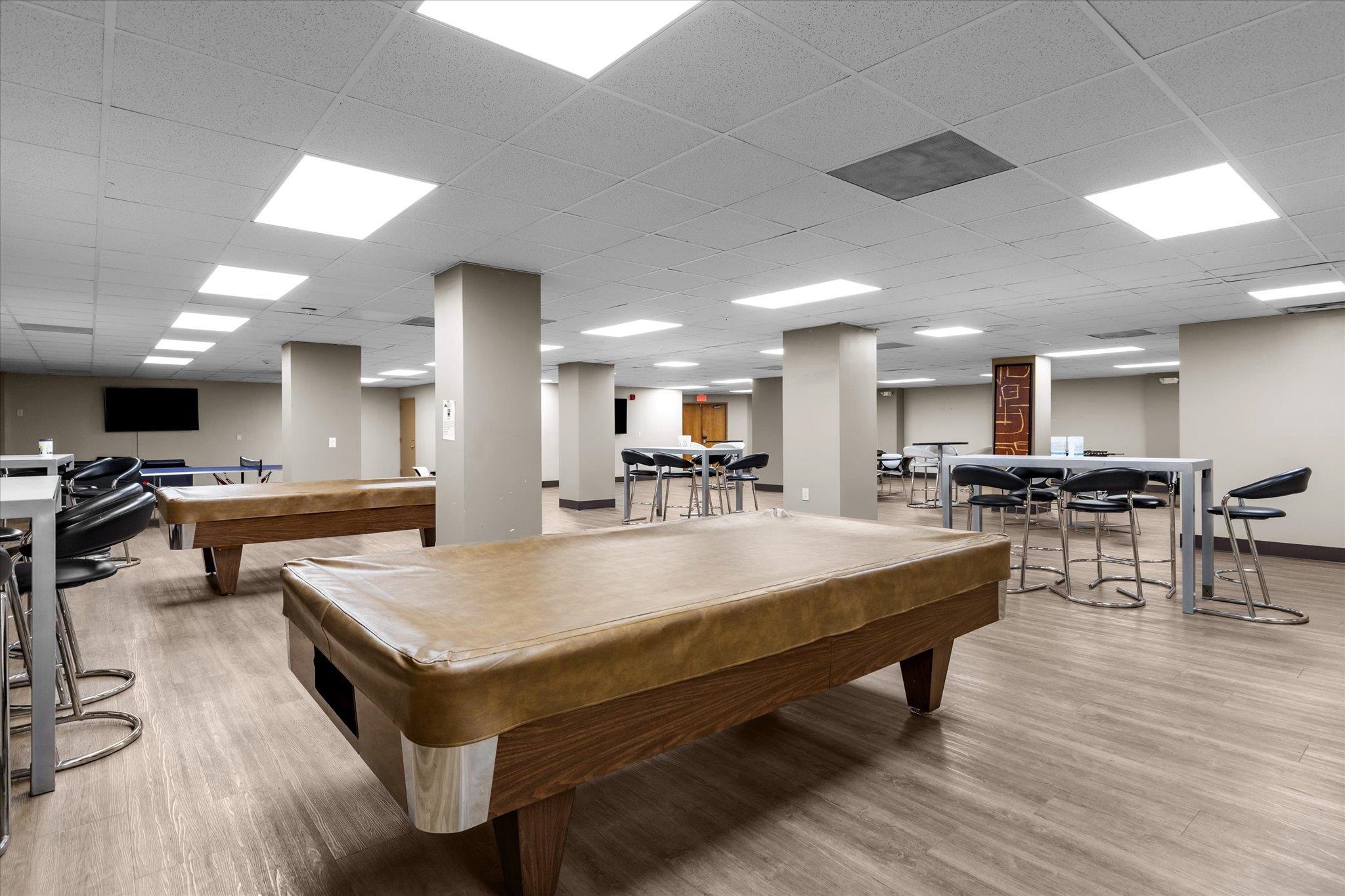 1705 Harmon Cove Tower, Unit 1705 Secaucus, NJ 07094 - Photo 42 of 49 a living room with dining table tennis pool and a table