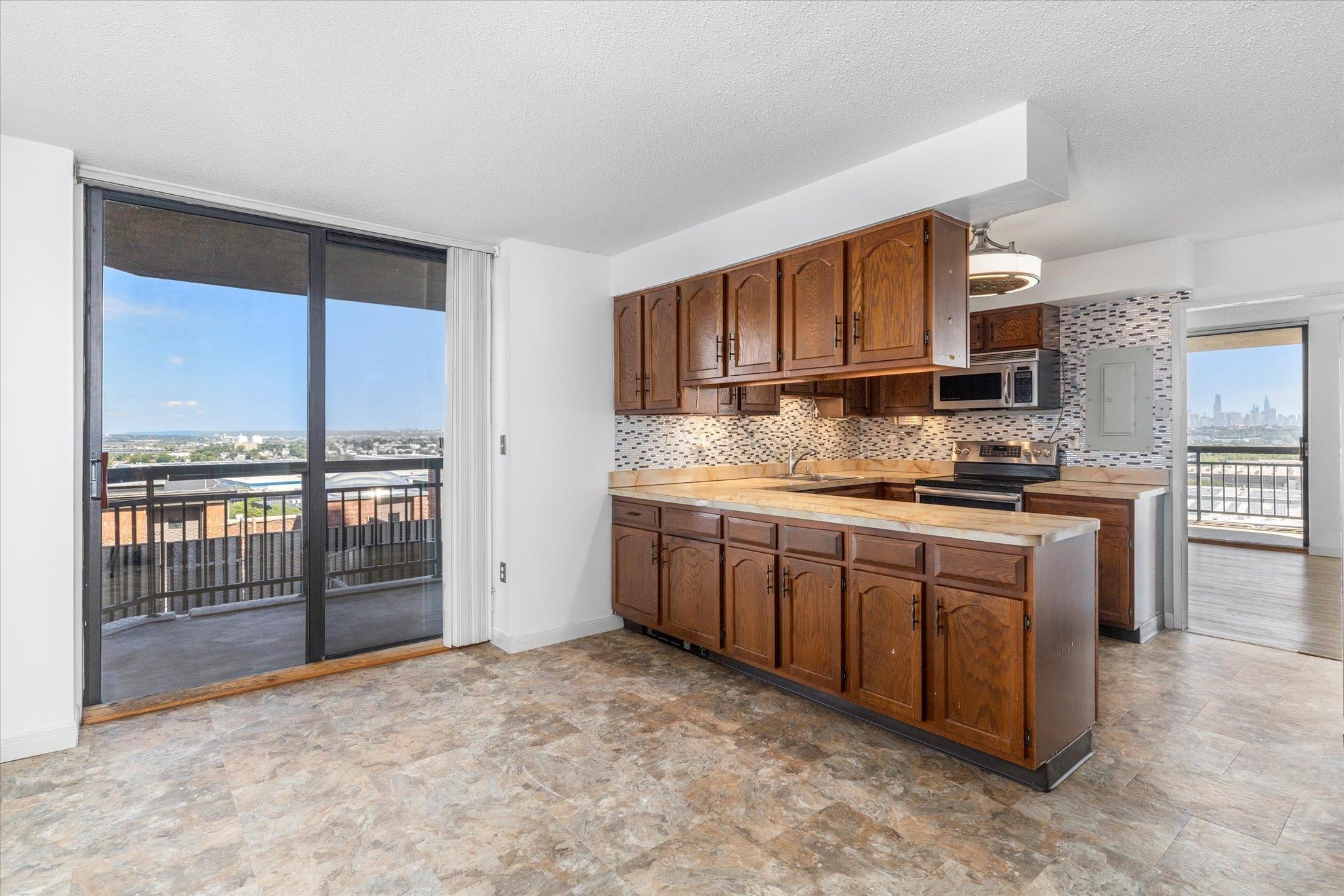 1705 Harmon Cove Tower, Unit 1705 Secaucus, NJ 07094 - Photo 5 of 49 a kitchen with stainless steel appliances granite countertop a stove a sink and a refrigerator
