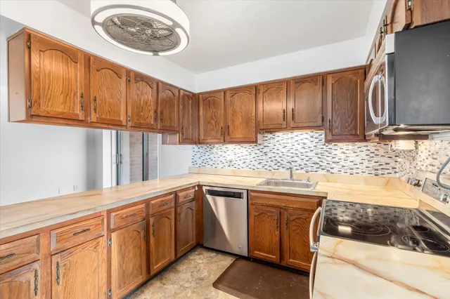 a kitchen with a sink stove and cabinets
