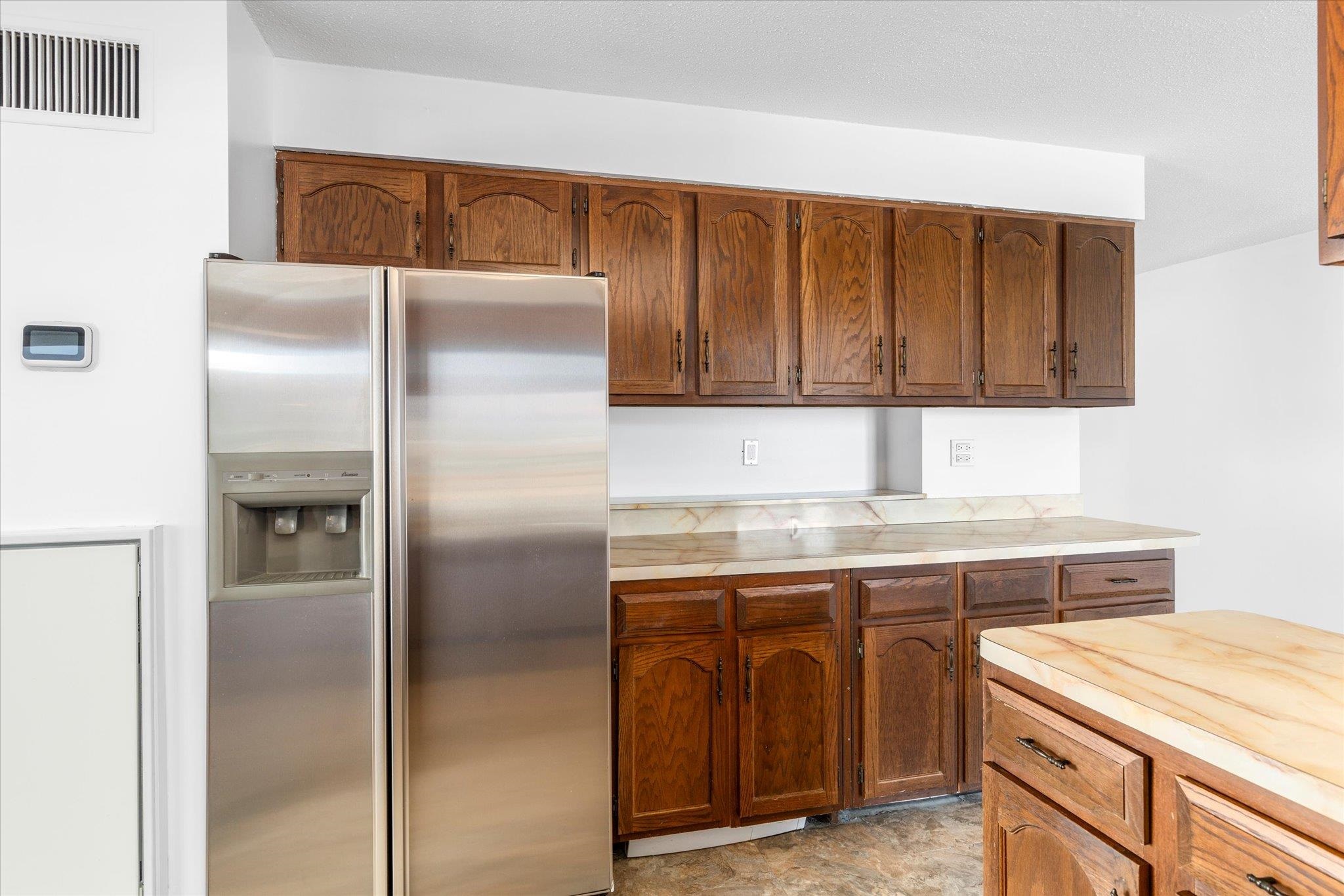 1705 Harmon Cove Tower, Unit 1705 Secaucus, NJ 07094 - Photo 9 of 49 a kitchen with a refrigerator and cabinets