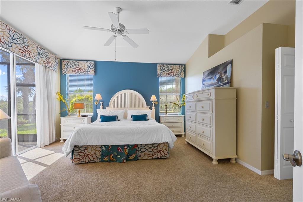 10305 Cape Roman Road, Unit 101 Estero, FL 34135 - Photo 4 of 27 Bedroom with visible vents, baseboards, a ceiling fan, light colored carpet, and access to exterior