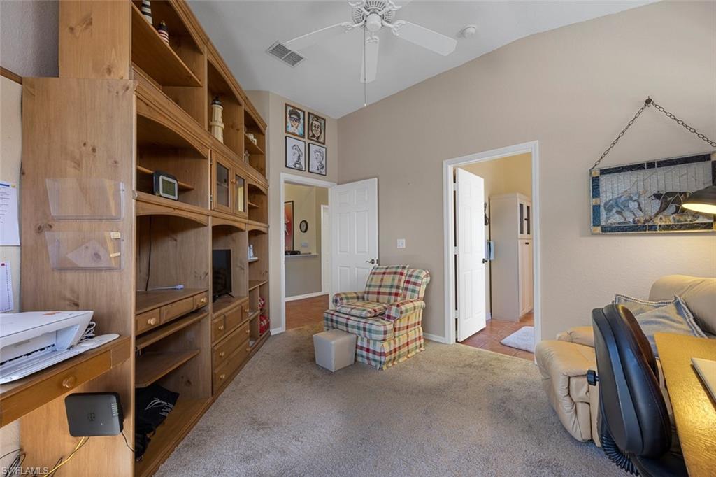 10305 Cape Roman Road, Unit 101 Estero, FL 34135 - Photo 5 of 27 Sitting room featuring lofted ceiling, carpet, visible vents, and a ceiling fan