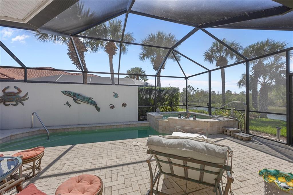10305 Cape Roman Road, Unit 101 Estero, FL 34135 - Photo 8 of 27 Outdoor pool with a lanai, a patio, and an in ground hot tub